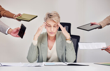 Canvas Print - The joys of being their manager. a mature businesswoman sitting in the office and feeling stressed while her colleagues put pressure on her.