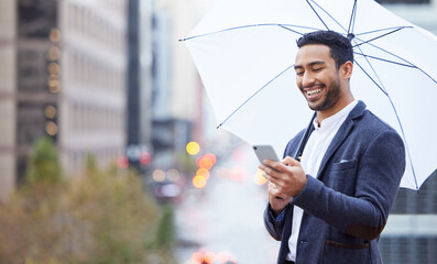 Aufkleber - Getting insurance is as simple as sending a text. a handsome young businessman sending a text while standing outside with an umbrella in the city.