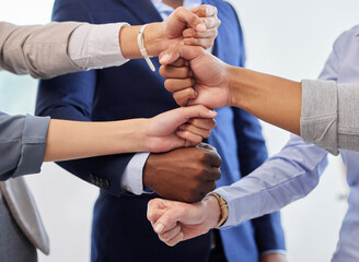 Poster - We can do anything we put our minds to. a group of unrecognizable businesspeople stacking their hands on top of each other.