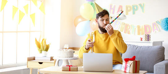 Canvas Print - Young man with laptop celebrating Birthday at home