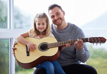 Poster - Shes a princess because her dads a king. a young father teaching his daughter to play the guitar at home.