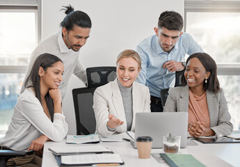 Fototapete - There is no such thing as a self-made man. a group of colleagues having a discussion in a office.