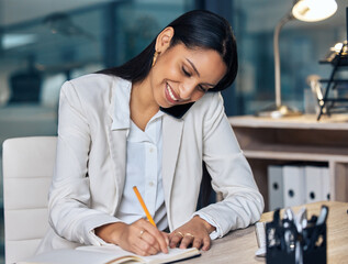 Canvas Print - Ill move your portfolio over right away. a young businesswoman sitting in her office at night and using her cellphone while writing in a notebook.