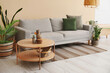 © Pixel-Shot - Interior of bright living room with cozy grey sofa, coffee table and houseplants