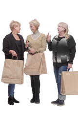 Wall Mural - in full growth. three happy women with shopping bags.