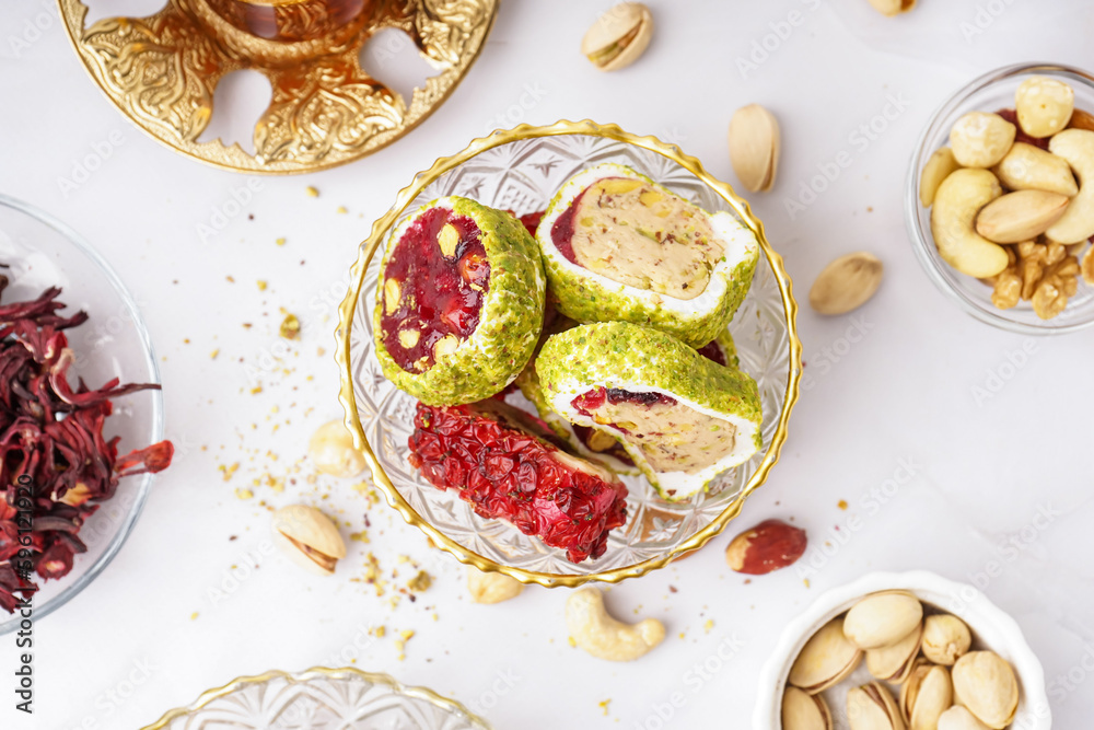 Bowl with tasty Turkish delight on light background