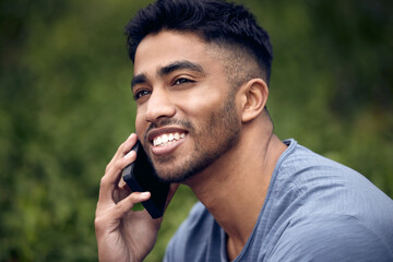 Poster - The guy everyone loves to get a call from. a young man using a smartphone while taking a break in a park.