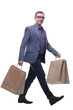 Young businessman wearing jeans and glasses with shopping bags
