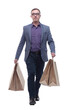 Picture of handsome smiling man in suit with shopping bags