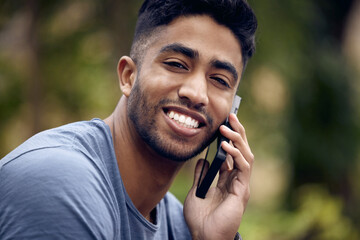 Leinwandbilder - Ive been waiting for your call. a young man using a smartphone while taking a break in a park.