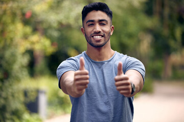 Poster - Life is as good as you make it. a young man showing thumbs up while standing outside at college.