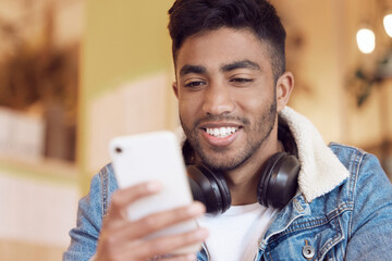 Poster - Life is for living. a young man using his smartphone to send a text message.