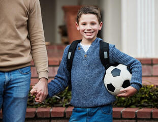 Canvas Print - Break time is going to be fun. a little boy ready to go to school holding a soccer ball.