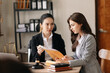 © Nuttapong punna - Asian business team and lawyers discussing contract papers sitting at the table. Concepts of law, advice, legal services. at office