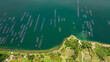 Aerial drone of Fish farm with cages on Maninjau lake. Farming aquaculture or pisciculture practices. Sumatra Indonesia.