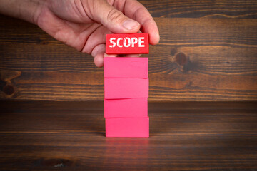 Wall Mural - Scope Concept. Red blocks in a pile on a wooden texture background