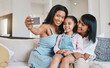 © Wesley JvR/peopleimages.com - Selfie, grandmother and kid with mother in home living room, bonding or having fun. Family, happiness and girl with grandma and mama, care and enjoying time together while taking pictures on sofa.
