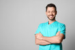 © New Africa - Doctor or medical assistant (male nurse) in uniform on light grey background. Space for text