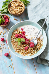 Sticker - Diet nutrition concept. Healthy breakfast cereal bowl homemade granola with fresh raspberry and chia seeds on a rustic table. Copy space.