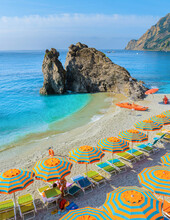 Monterosso Beach Vacation Chairs And Umbrellas On The Beach Of Cinque Terre Italy.
