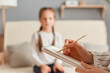 © sementsova321 - Closeup of doctor psychologist holding paper notebook making notes while talking with small girl at psychological therapy session meeting, blur defocused little kid patient.