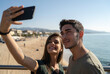 © Westend61 - Smiling young woman taking selfie with boyfriend through smart phone
