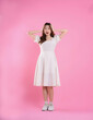 © STOCK88PHOTOGRAPHER - full body image of asian woman in skirt posing on pink background
