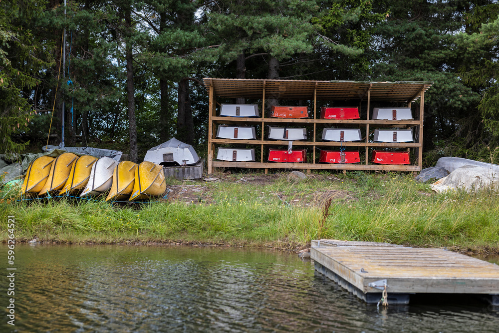 Rack of canoes on lakeshore Stock Photo | Adobe Stock