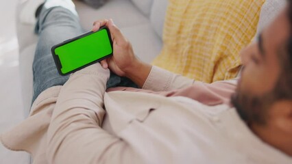Wall Mural - Man, smartphone and green mockup screen on sofa to relax on social media, online post and streaming. Guy, cellphone and blank mock up to download mobile games, search digital app and web connection