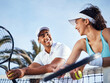 © Nicholas Felix/peopleimages.com - Were a powerful duo. Shot of two tennis players standing together and leaning on the net during practice.