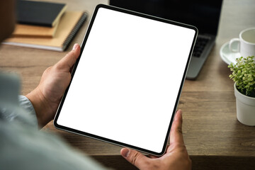 Poster - a businessman holds a mockup. ipad digital tablet with blank screen mockup replaces your design mock