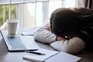 Sometimes your dreams are better than reality. Shot of a young businesswoman sleeping while working from home.