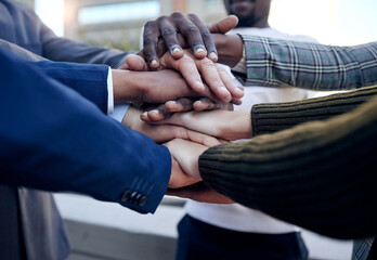 Poster - We support each other. Shot of a group of unrecognizable businesspeople stacking their hands outside.