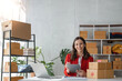 © Natee Meepian - Startup small business SME, Entrepreneur owner using tablet taking receive and checking online purchase shopping order to preparing pack product box. Selling online ideas concept