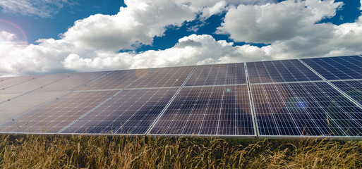 Solar panels and blue sky with clouds