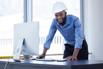 Wall Mural - Figuring out a plan. Shot of a young businessman using a computer at work.