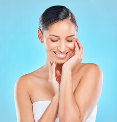 Wall Mural - Skin as soft as silk. Studio shot of an attractive young woman posing against a blue background.