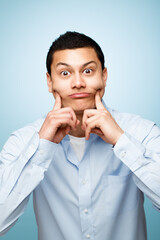 Poster - What a cute face. Shot of a young man making facial expressions against a studio background.