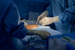 © Issara - Doctor or surgeon in blue surgical gown did surgery inside operating room in hospital.People did sensory testing after general anesthesia in patient undergo abdominal surgery.Spinal anesthetic block.