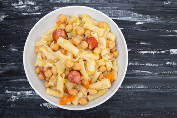 Sticker - chick pea with smoked sausages, pasta and cabbage in white bowl