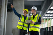 © VStudio - Civil Engineer and Construction Supervisor inspect the internal construction of building at construction site. Construction engineers or architect and Foreman inspect the construction inside building.