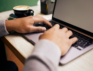 Poster - Closeup of unknown mixed race man sitting alone in cafe and using a laptop to browse the internet. Hispanic student typing and researching online. Macro view of man using technology to learn a course