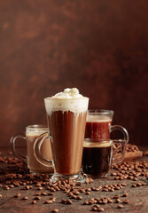 Wall Mural - Various coffee and chocolate drinks on a brown background.