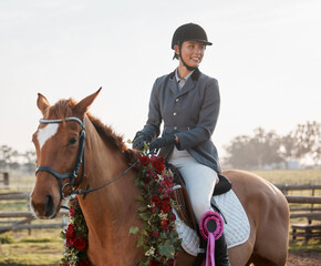 Poster - The winning team. Cropped shot of a young female jockey sitting on her wreath-wearing horse after winning a race.