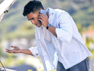 Poster - Im so confused.... Cropped shot of a handsome young man on the phone with roadside assistance after suffering a vehicle breakdown.