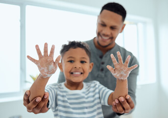 Poster - Ten less places for germs to hide. Shot of an adorable little boy washing his hands with the help of his father at home.