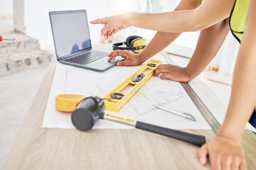 Poster - Can we go with this design. Cropped shot of two unrecognisable contractors standing inside together and using a laptop while planning.