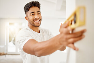 Poster - I prefer doing the work myself. Shot of a handsome young man standing alone in his home and using a ruler to measure a wall.