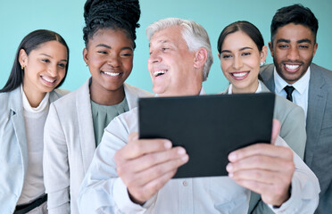 Poster - Thats an awesome picture. Studio shot of a diverse group of corporate businesspeople using a tablet to take selfies against a blue background.