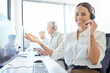 Need a solution Look no further. Shot of a young woman wearing a headset while working in a call center.
